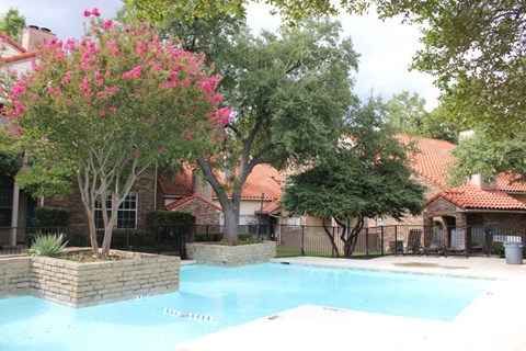 a large swimming pool in front of a house